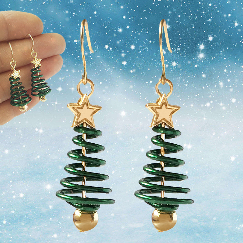 Green spiral earrings with gold stars against a snowy background